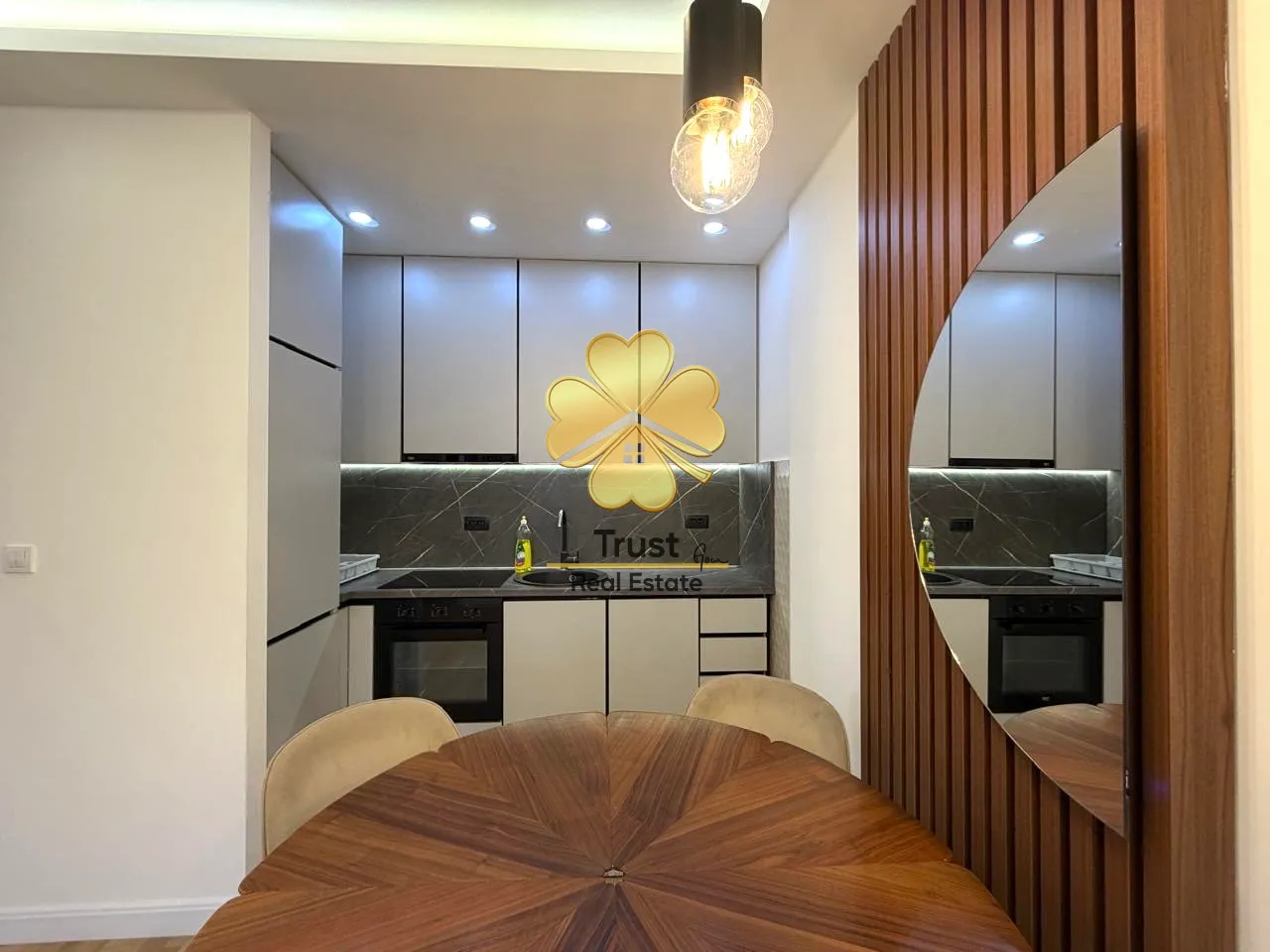 Modern kitchen with dining table and built-in appliances.
