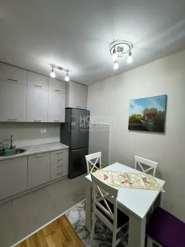 Small kitchen with a dining table and chairs. - image 2