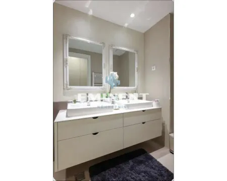 Bathroom with double sinks and mirrors. - image 16