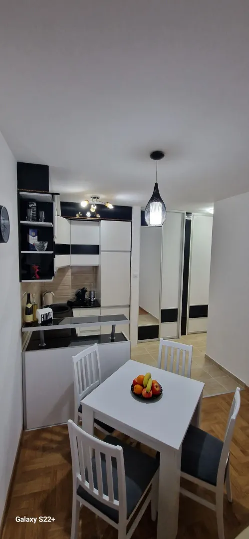 Modern kitchen with a dining table and chairs.