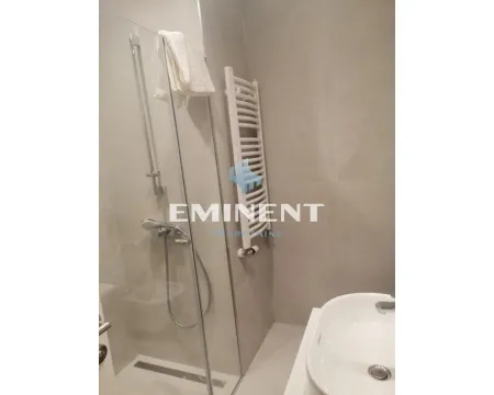 Modern bathroom with a shower cabin and a washbasin. - image 4