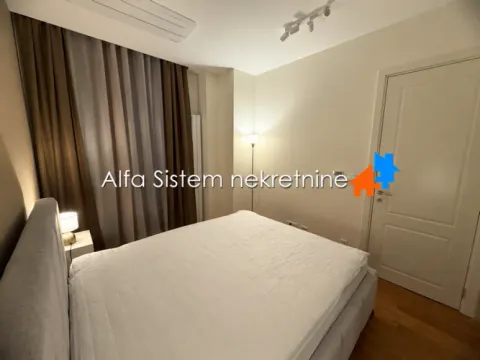 Furnished bedroom with a double bed, curtains, and a white door. - image 6