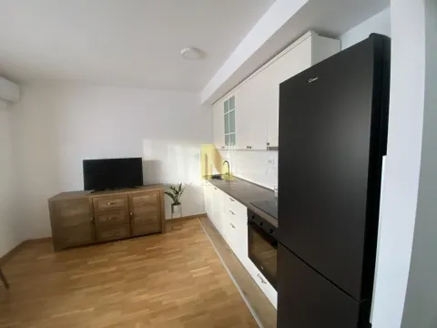 Small kitchen with white units and a black refrigerator. - image 6