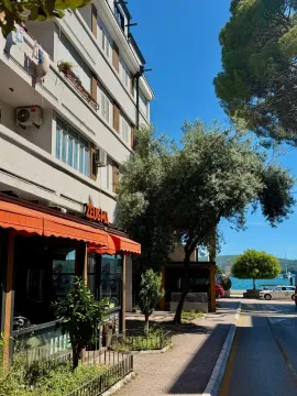 Exterior of the building with a view of the street and the waterfront. - image 16