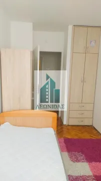 Children's bedroom with a bed, wooden wardrobes, and laminate flooring. - image 11