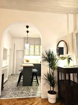 View from the living room towards the kitchen with a dining island. - image 2