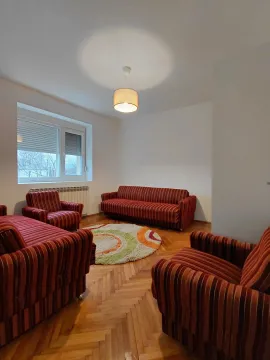 Living room with seating furniture and parquet flooring. - image 7