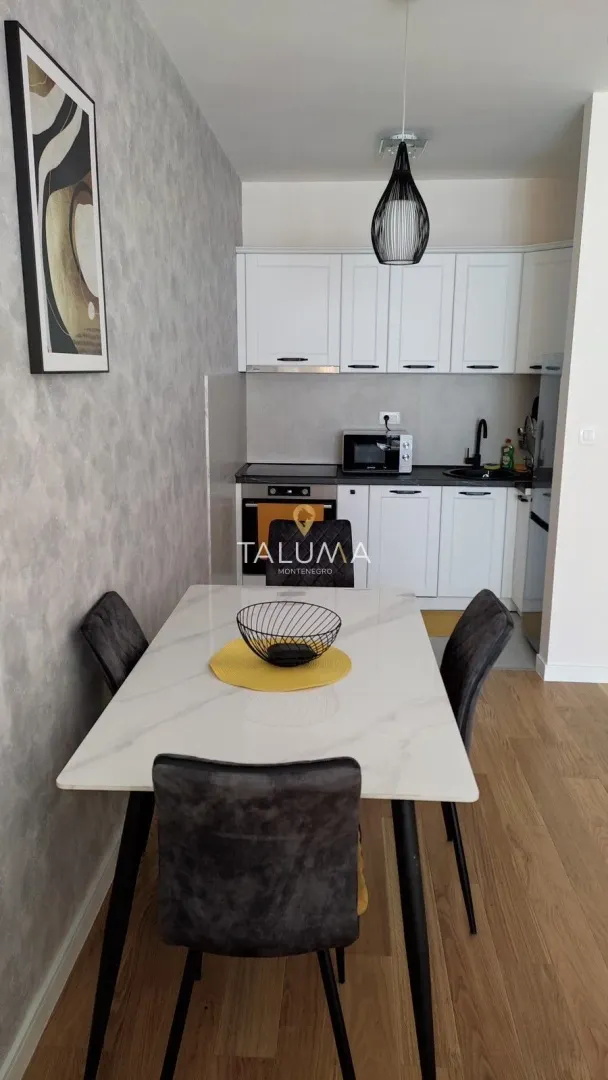 Kitchen with dining table and white cabinets.
