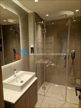 Modernly equipped bathroom with a washbasin and a walk-in shower. - image 11