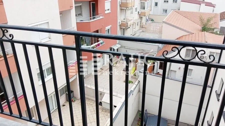 View from the balcony overlooking surrounding buildings and courtyard.