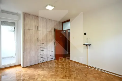 Empty bedroom with a built-in wardrobe and parquet flooring. - image 18