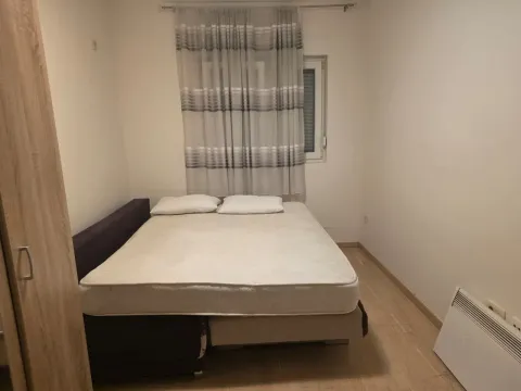 Bedroom with a double bed, wardrobe, and a window with curtains. - image 7