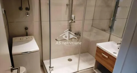 Modern bathroom with a shower cabin, washbasin, and washing machine. - image 17
