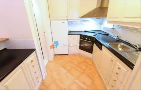 Small kitchen with white cabinetry and dark countertops. - image 14