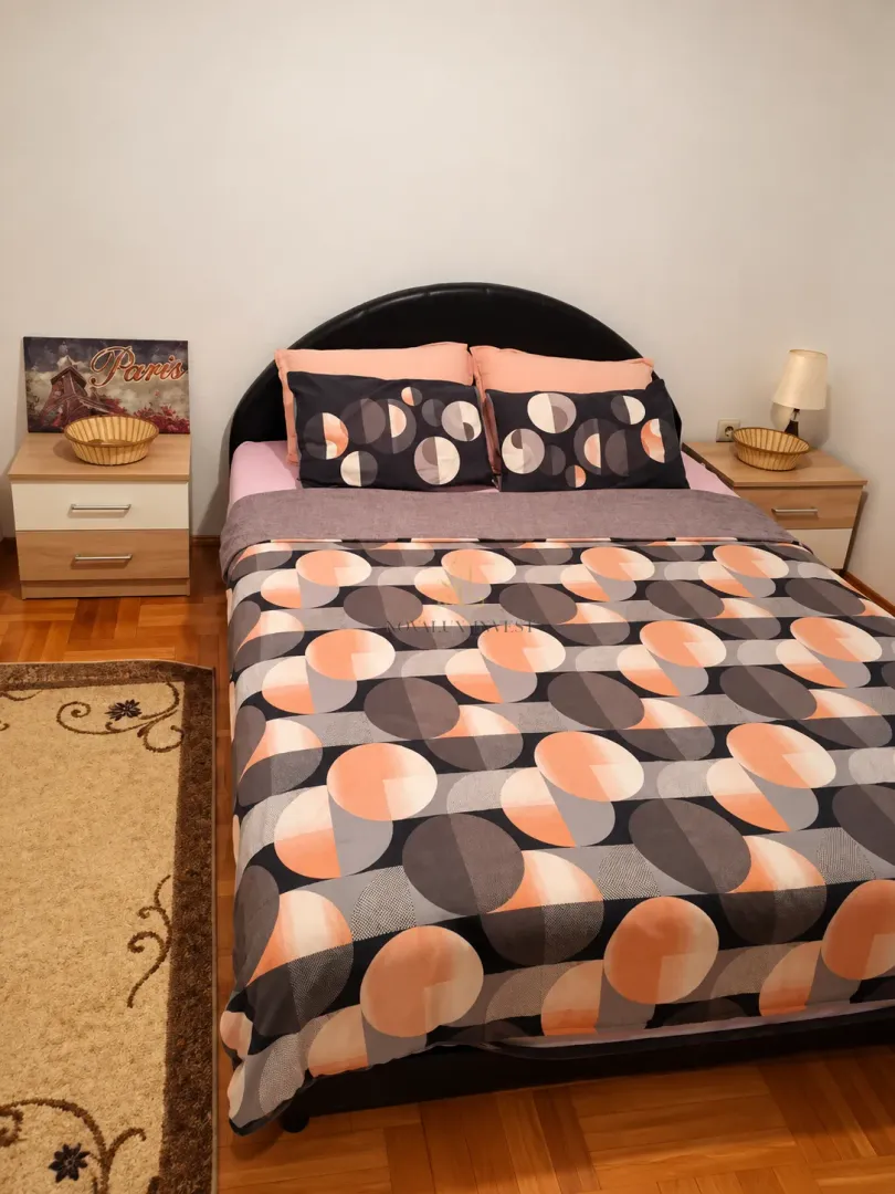 Bedroom with a double bed, nightstands, and a rug.