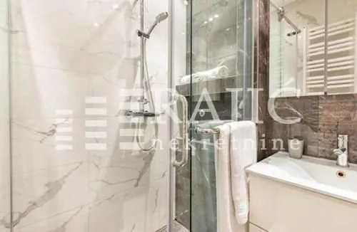 Modern bathroom with a shower cabin and a sink.