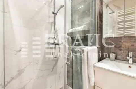 Modern bathroom with a shower cabin and a sink. - image 11