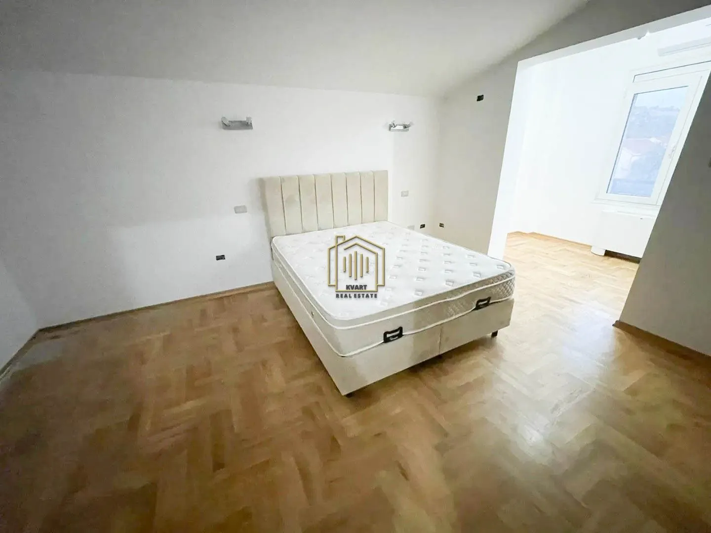 Bedroom with a double bed and parquet flooring.