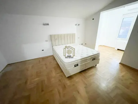 Bedroom with a double bed and parquet flooring. - image 6