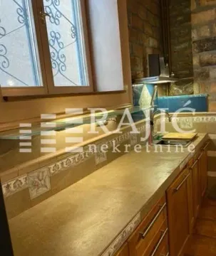 View of a kitchen section with countertops and a window. - image 15