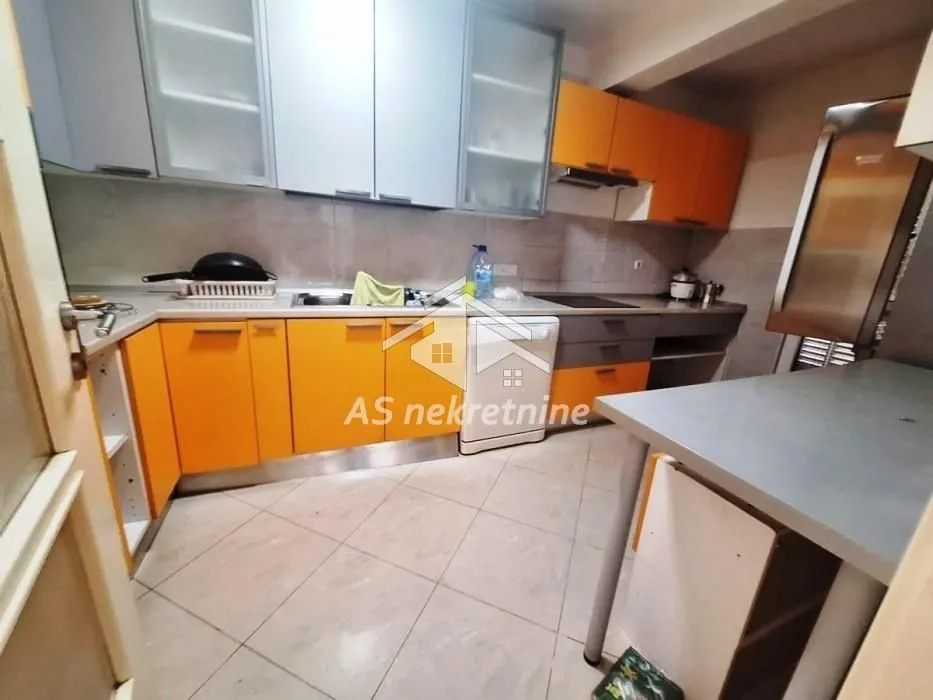 Kitchen with orange cabinets and a sink.