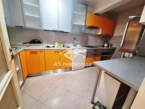 Kitchen with orange cabinets and a sink. - image 6