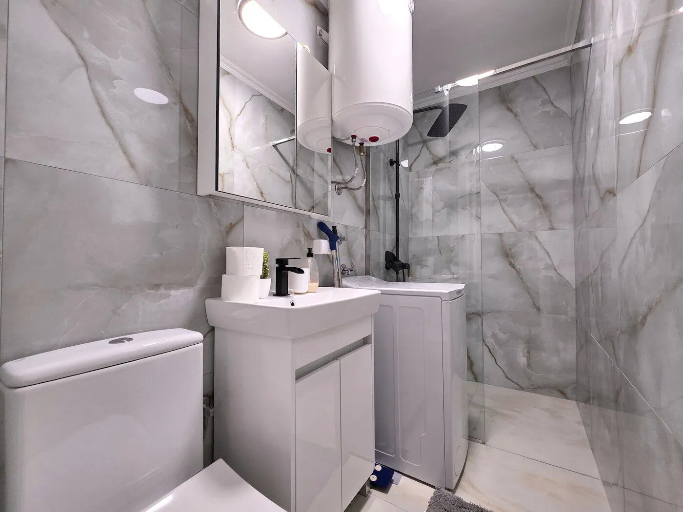 Moderno opremljeno kupatilo sa tuš kabinom, umivaonikom i wc šoljom.