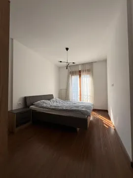 Bedroom with a double bed, wooden flooring, and a window with natural light. - image 7