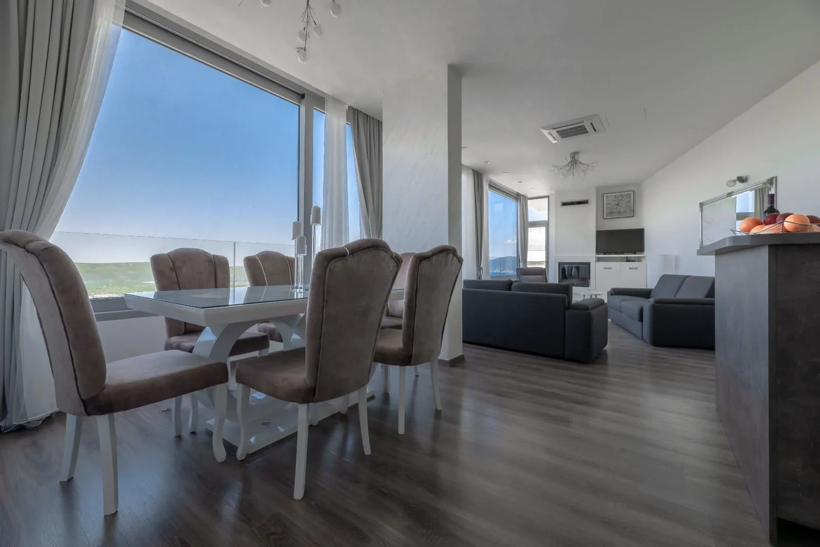Spacious living room with a dining area and large windows with a view.