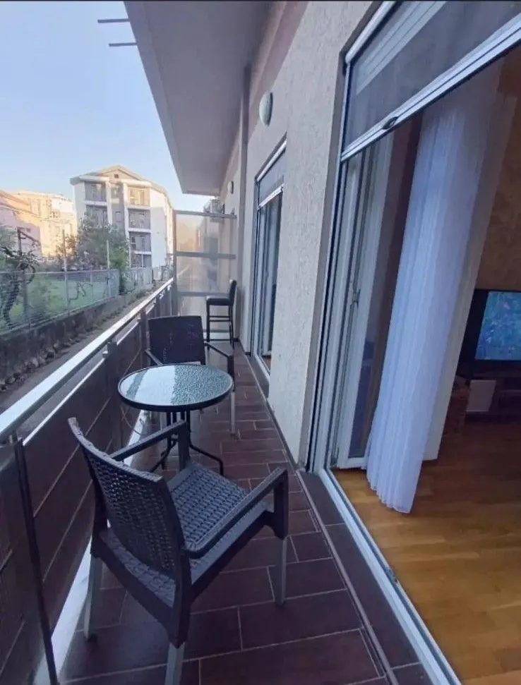 Spacious balcony with seating set and view of the surroundings.