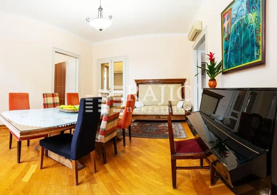 Living room with dining area and piano.