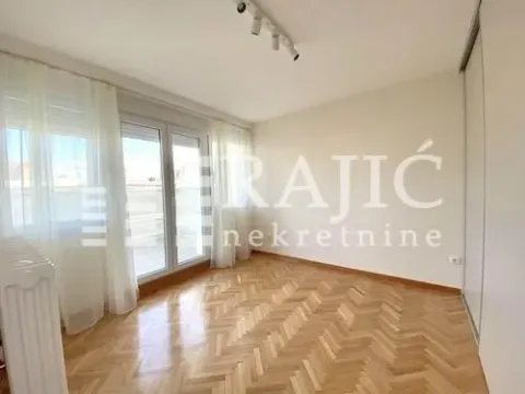 Empty room with parquet flooring and balcony doors. - image 11