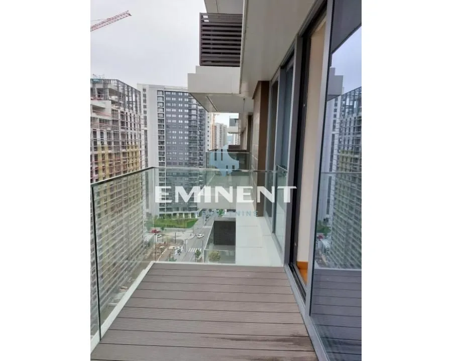 Long balcony with wooden decking and city view.