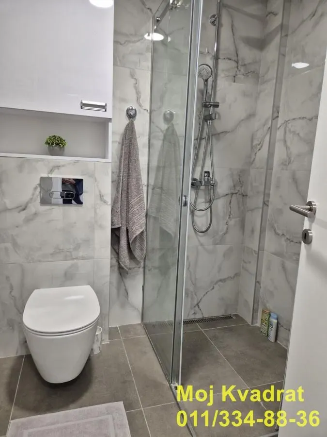 Modern bathroom with a walk-in shower and built-in sanitaryware.