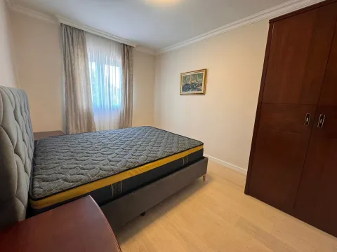 Bedroom with a double bed, wooden wardrobe and a window. - image 16