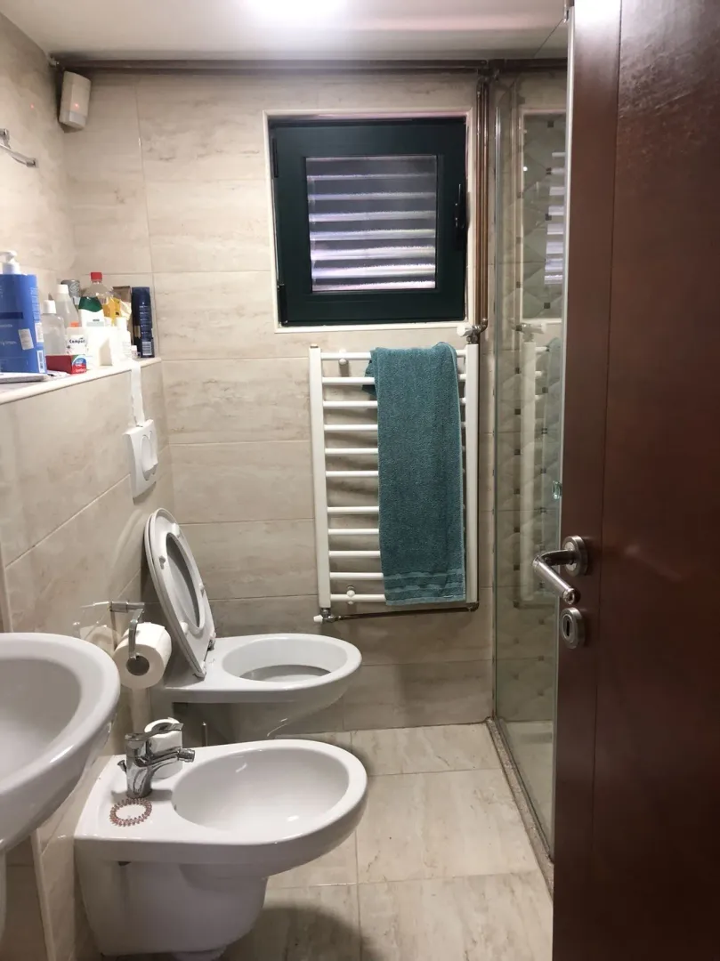 Bathroom with a toilet, bidet, and shower cabin.