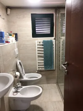Bathroom with a toilet, bidet, and shower cabin. - image 13