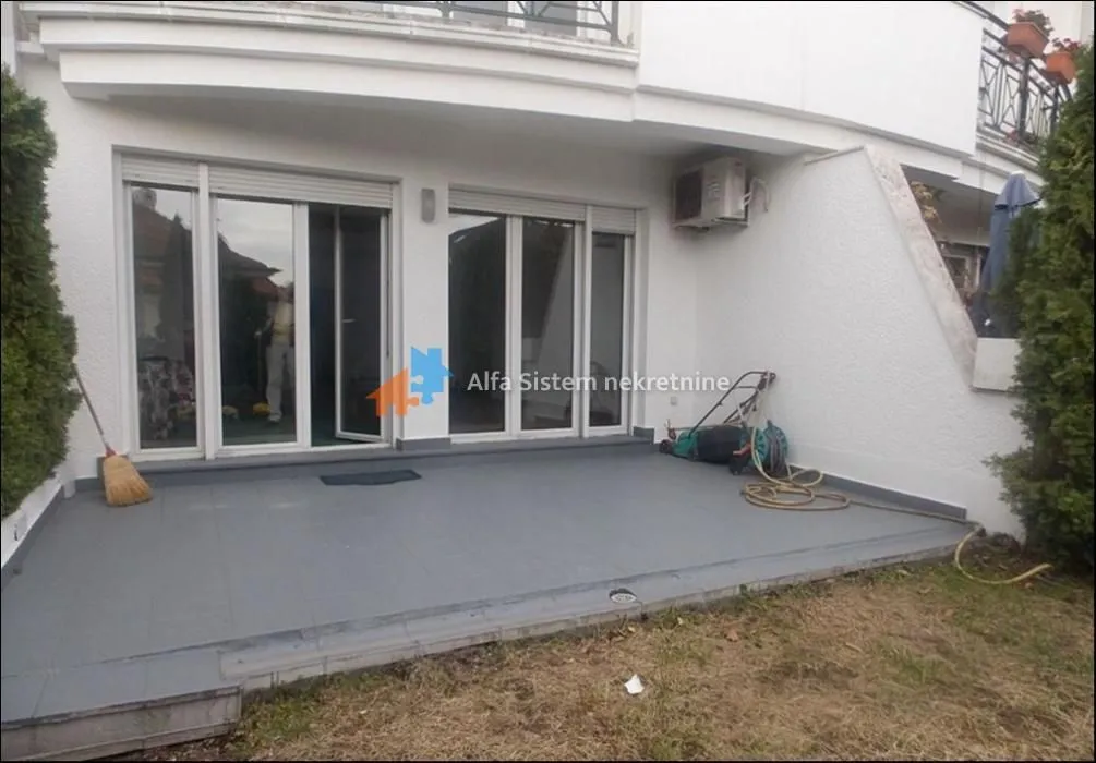 Tiled terrace in front of the ground floor entrance of the house.