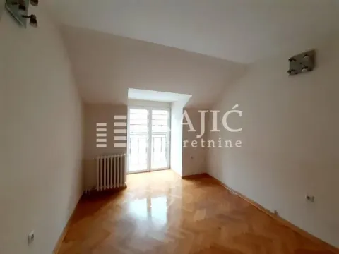 Empty room with parquet flooring and balcony doors. - image 4