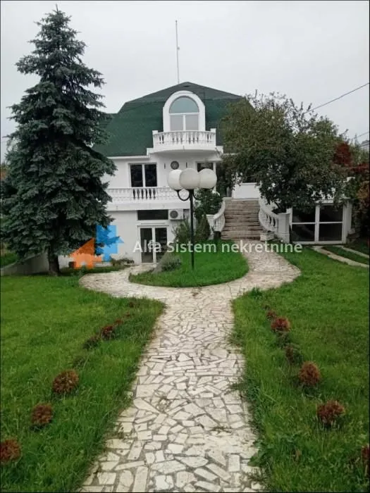 Exterior view of the house with a landscaped yard and pathway.