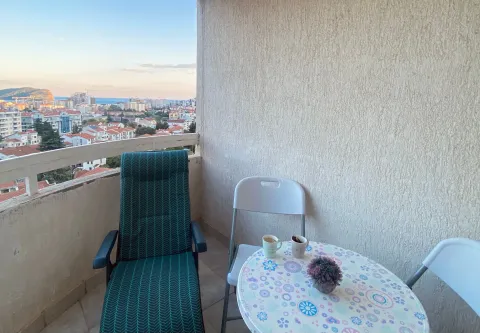 Furnished terrace with a table, chairs, and a city view. - image 3