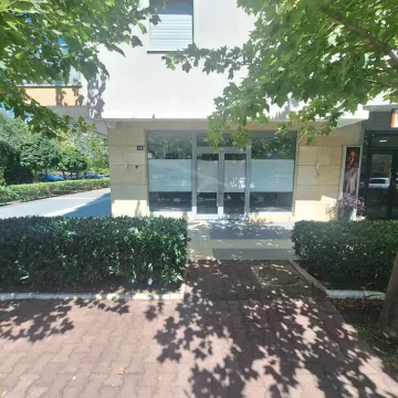 View of the entrance to the commercial space with a glass storefront. - image 2