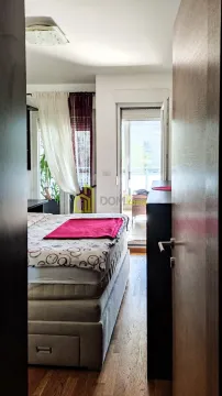 View from the hallway into the bedroom with a bed and access to the terrace. - image 4