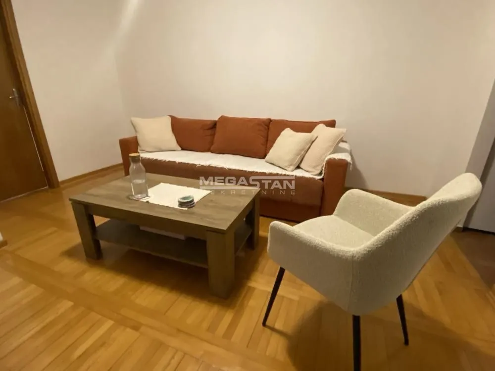 Living room with a sofa, armchair and coffee table.