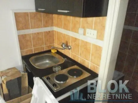 Small kitchen with a sink, electric hob, and ceramic wall tiles. - image 5