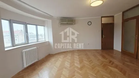 Empty room with parquet flooring and large windows. - image 4