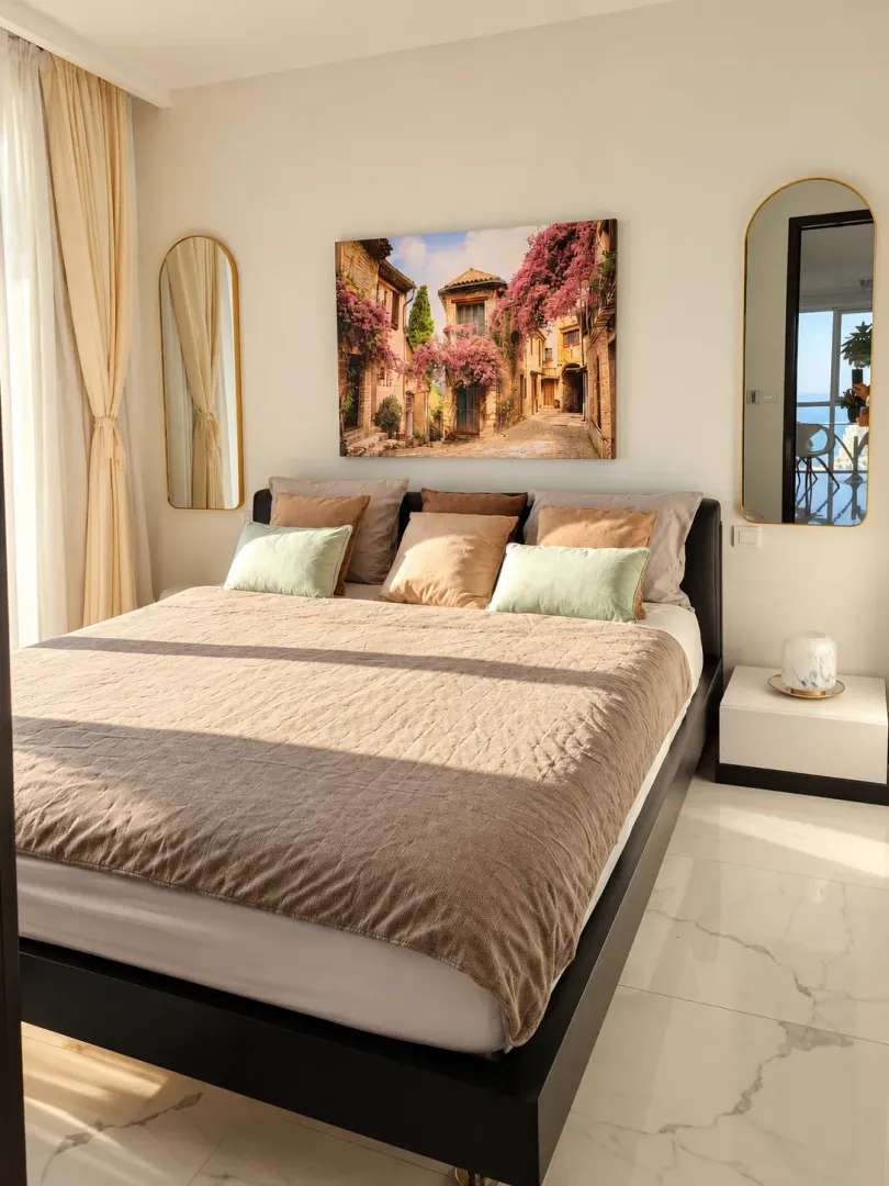 Bright and tidy bedroom with a double bed and mirrors.