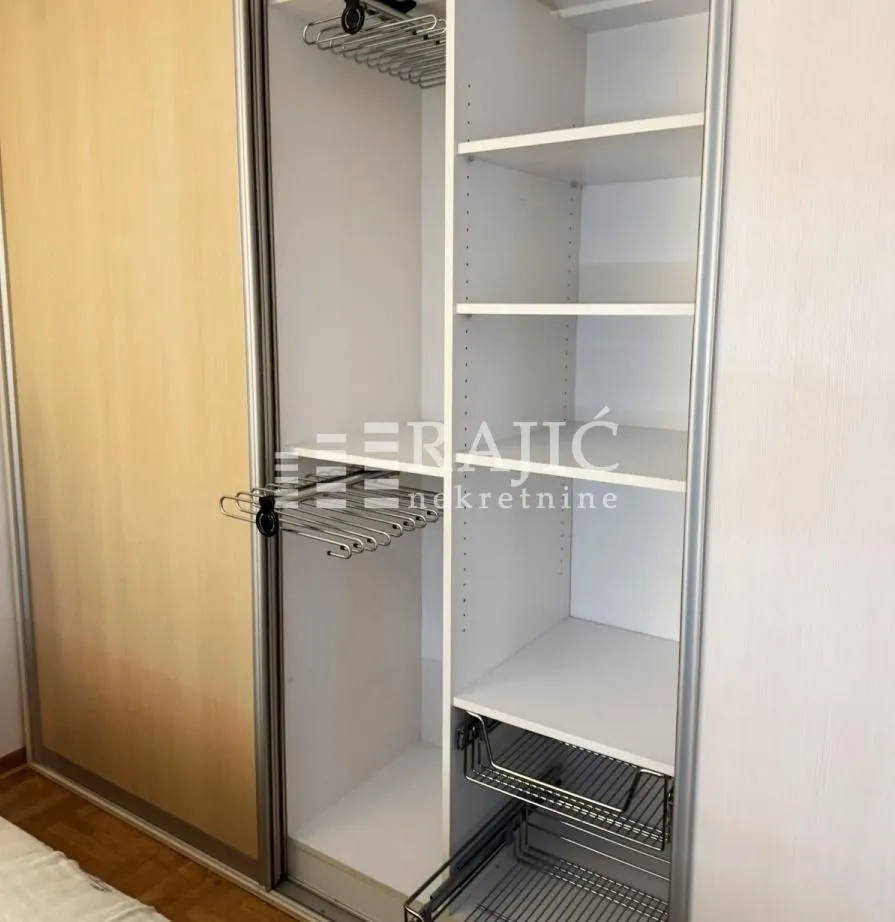 Open built-in wardrobe with shelves and drawers.
