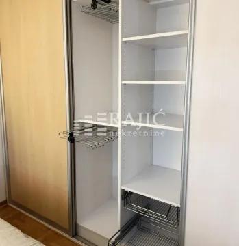 Open built-in wardrobe with shelves and drawers. - image 9