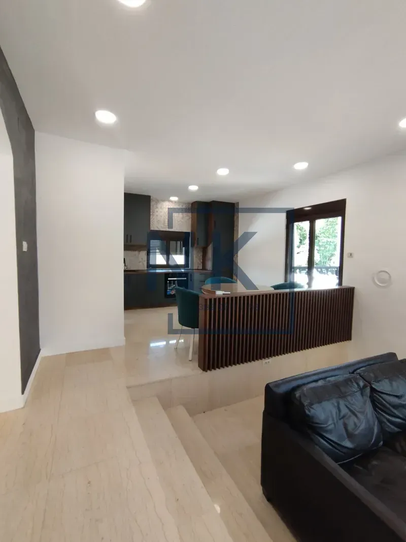 Living room with a view of the kitchen and dining area.